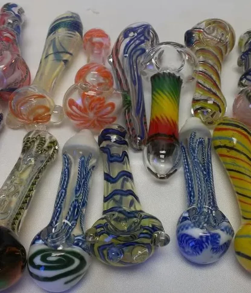 Assorted glass pipes displayed on a table, showcasing various colors and designs.